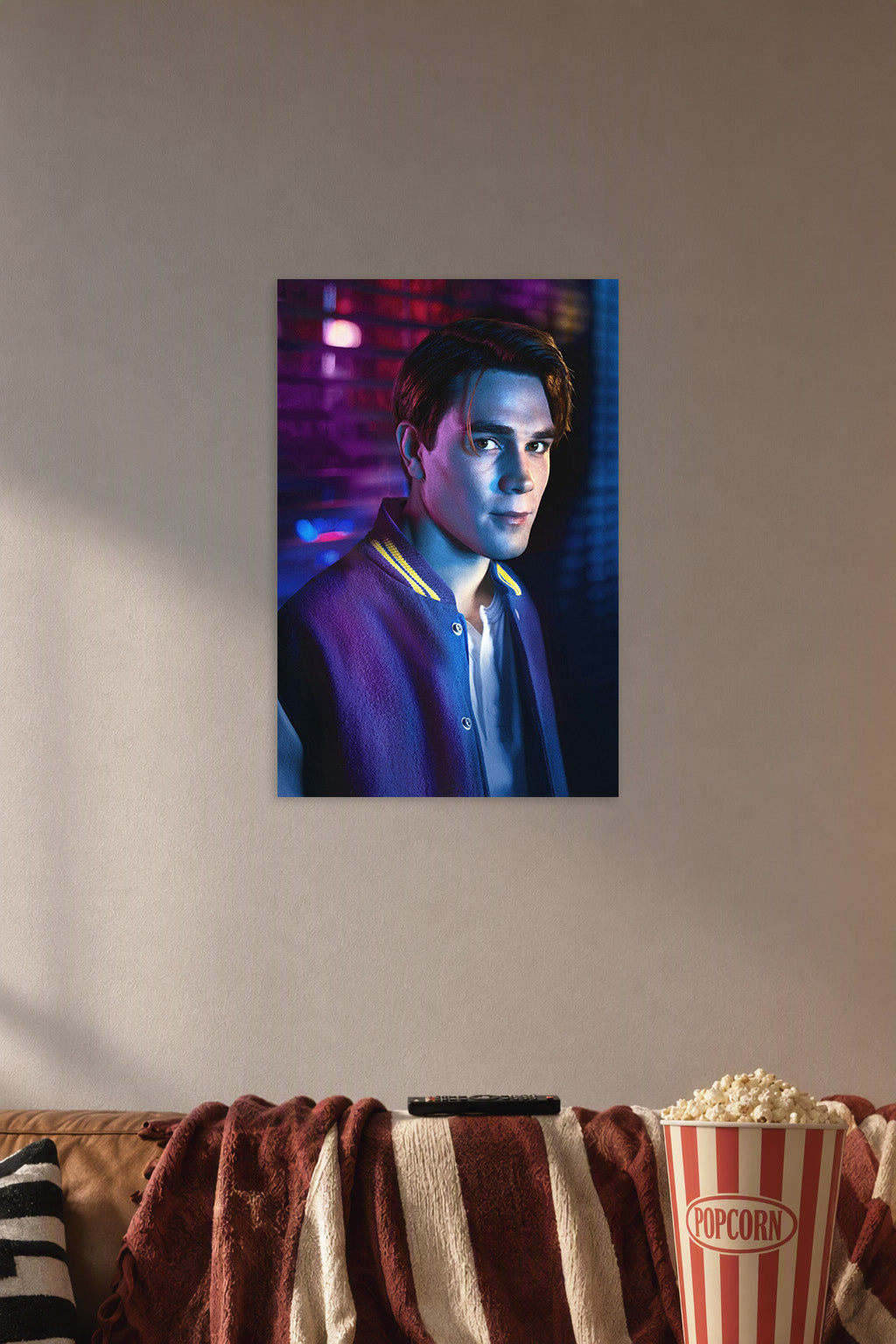 Archie Andrews Riverdale in a cozy movie room above a brown sofa with popcorn.