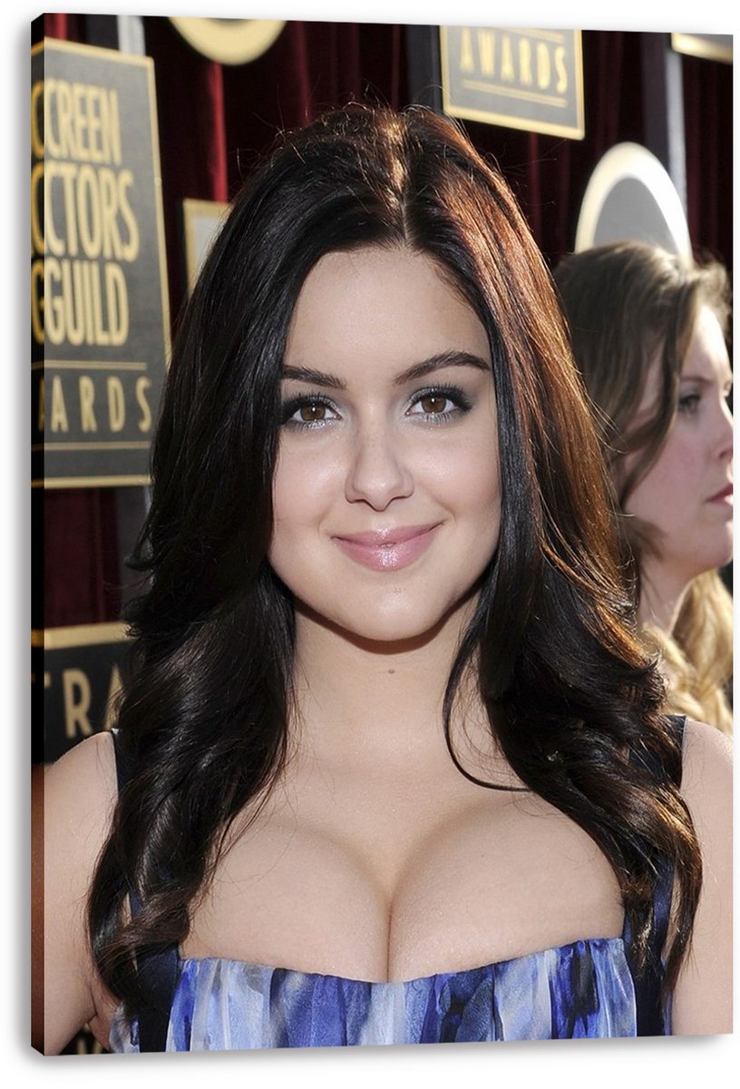 Ariel Winter canvas wall art print with a smiling close-up awards-event portrait, blue patterned dress, red curtain backdrop, and visible wrapped edges.