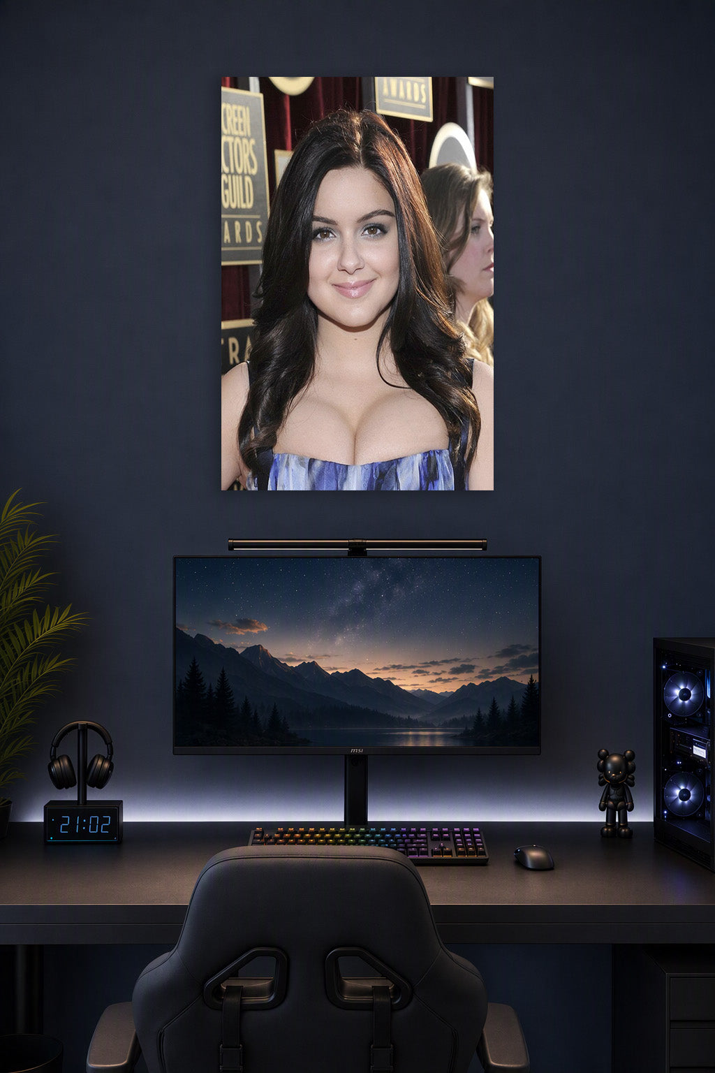 Ariel Winter in a gaming desk setup above a monitor.