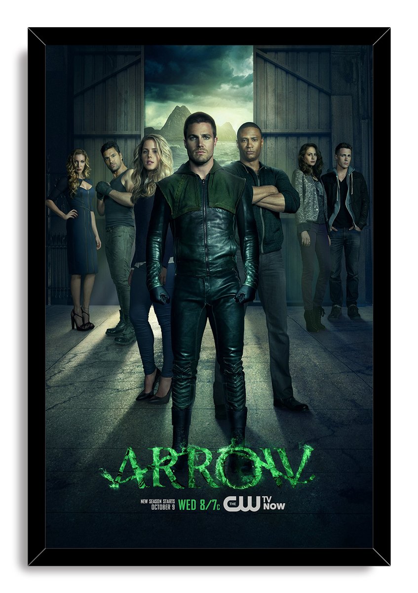 Arrow framed wall art print presents Oliver Queen in green-and-black gear surrounded by cast members against a moody mountain backdrop.