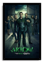 Arrow framed wall art print presents Oliver Queen in green-and-black gear surrounded by cast members against a moody mountain backdrop.