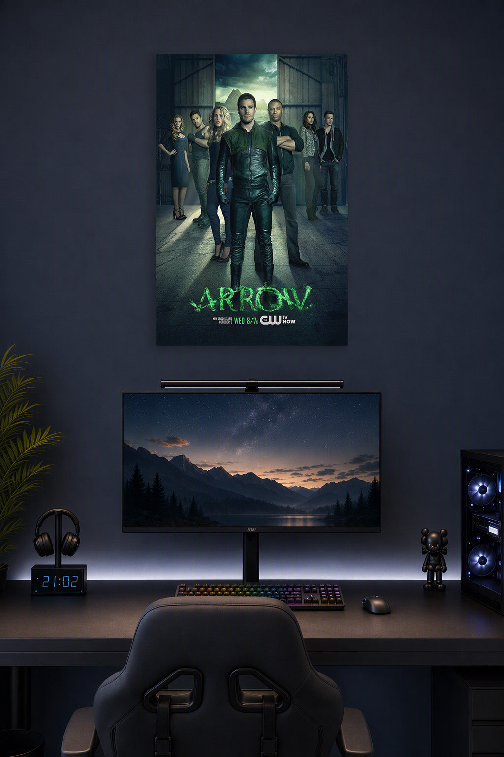 Arrow TV Series Cast in a gaming desk setup above a monitor.