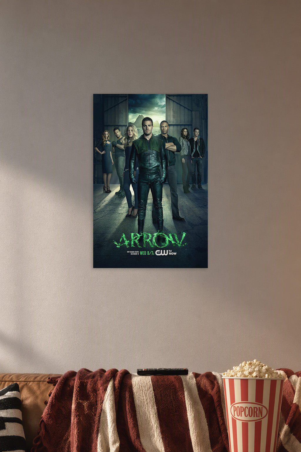 Arrow TV Series Cast in a cozy movie room above a brown sofa with popcorn.
