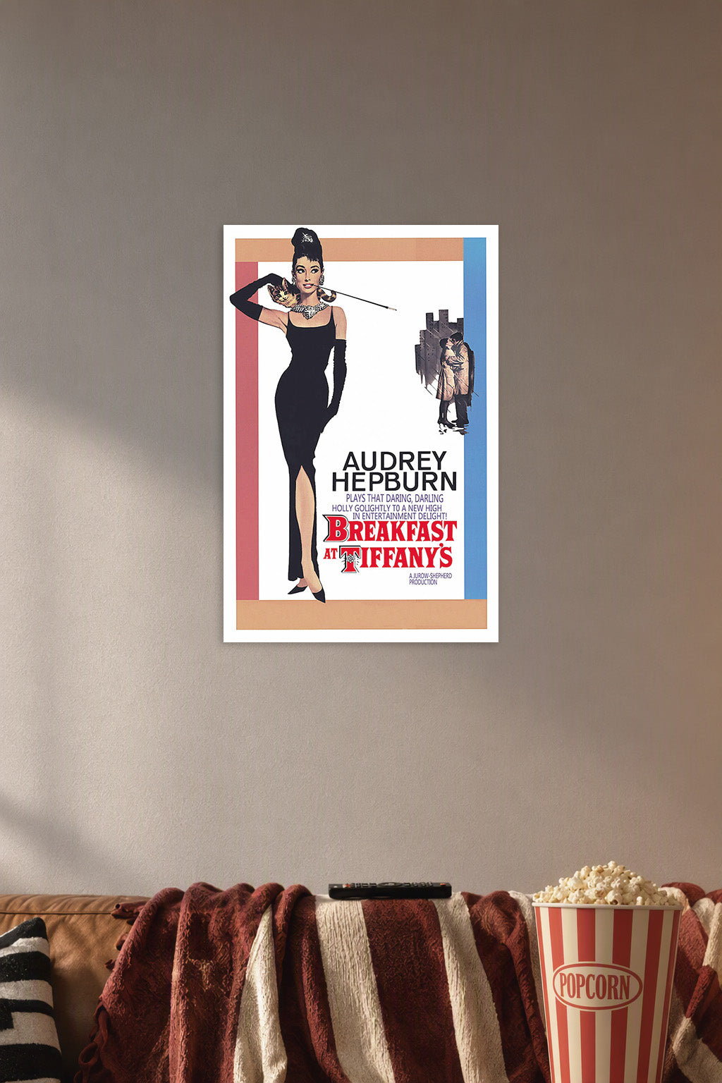 Audrey Hepburn Breakfast at Tiffany's in a cozy movie room above a brown sofa with popcorn.