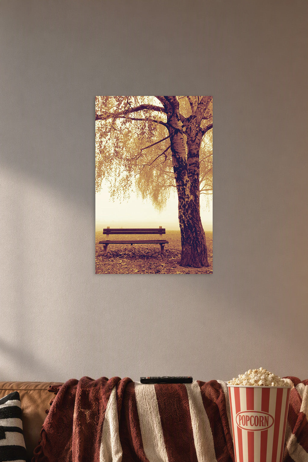 Autumn Park Bench and Tree in a cozy movie room above a brown sofa with popcorn.