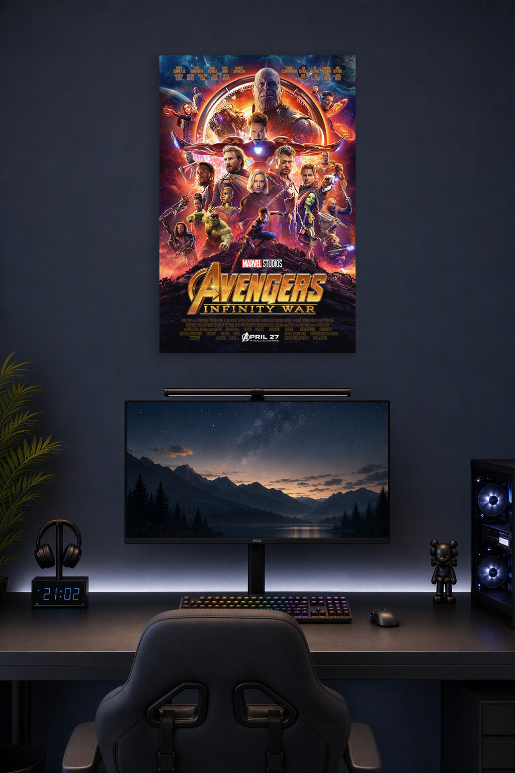 Avengers Infinity War Movie Poster in a gaming desk setup above a monitor.