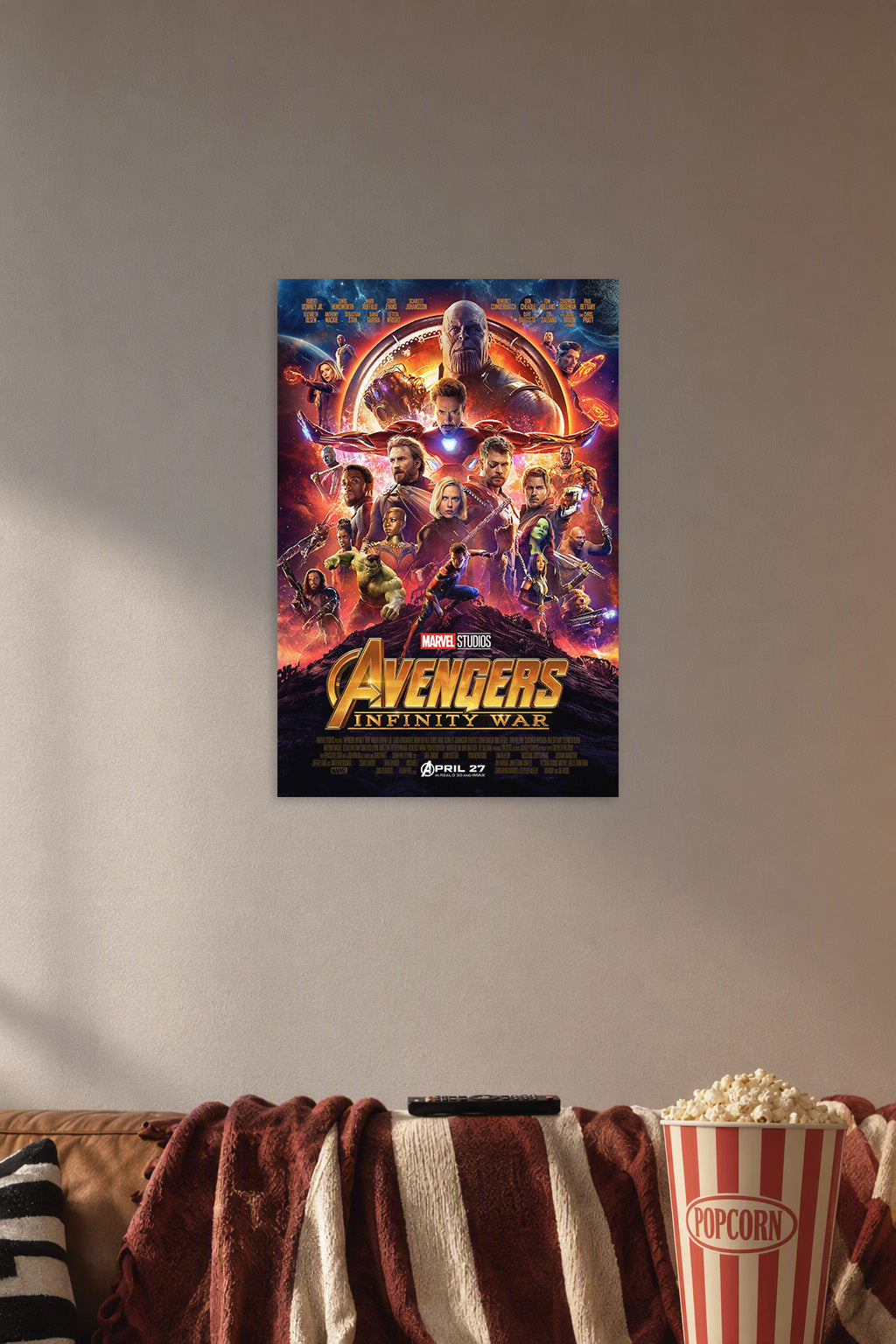Avengers Infinity War Movie Poster in a cozy movie room above a brown sofa with popcorn.