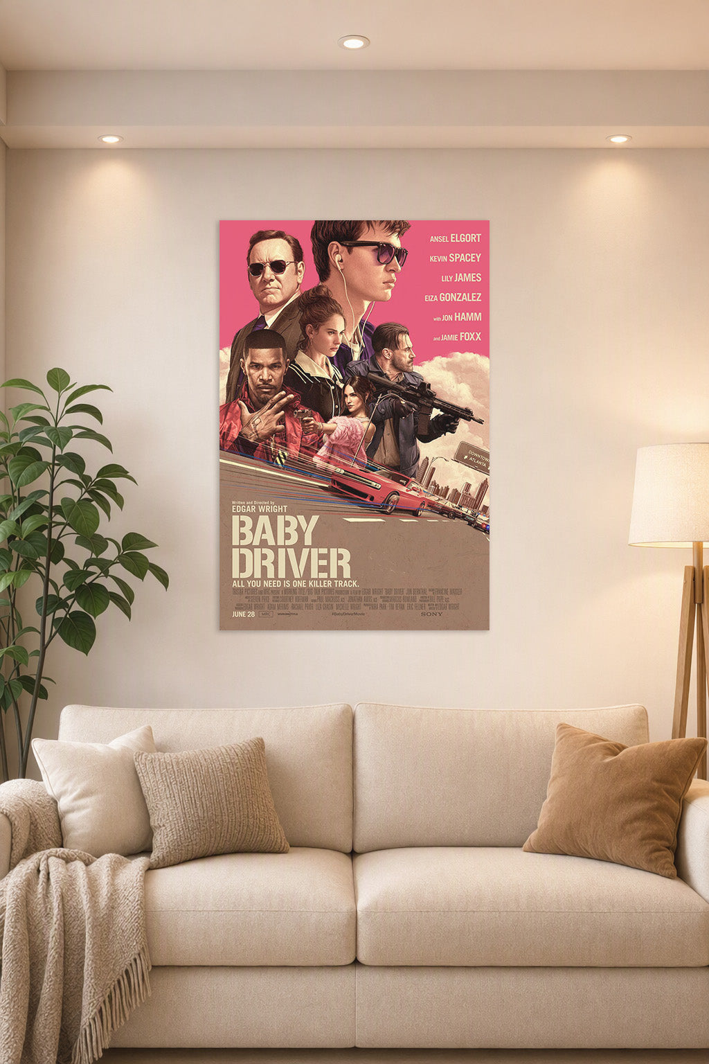 Baby Driver Movie Poster in a bright living room above a beige sofa.