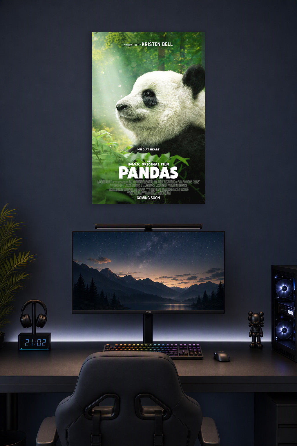 Baby Panda in a gaming desk setup above a monitor.