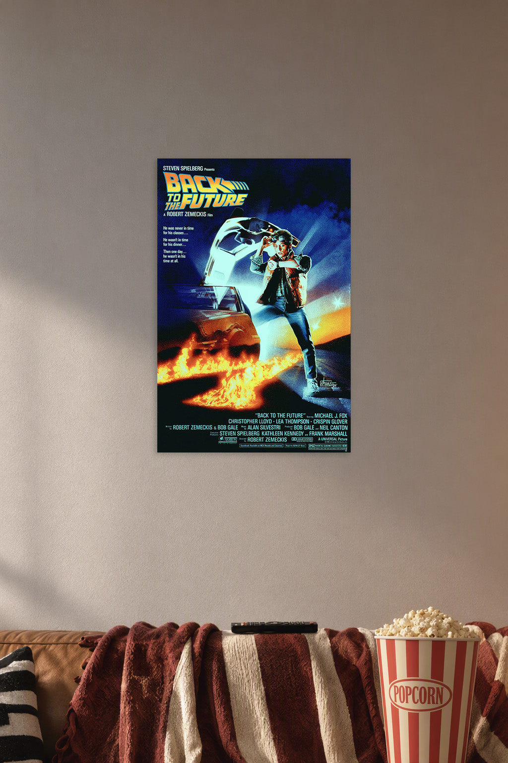 Back to the Future Movie Poster in a cozy movie room above a brown sofa with popcorn.