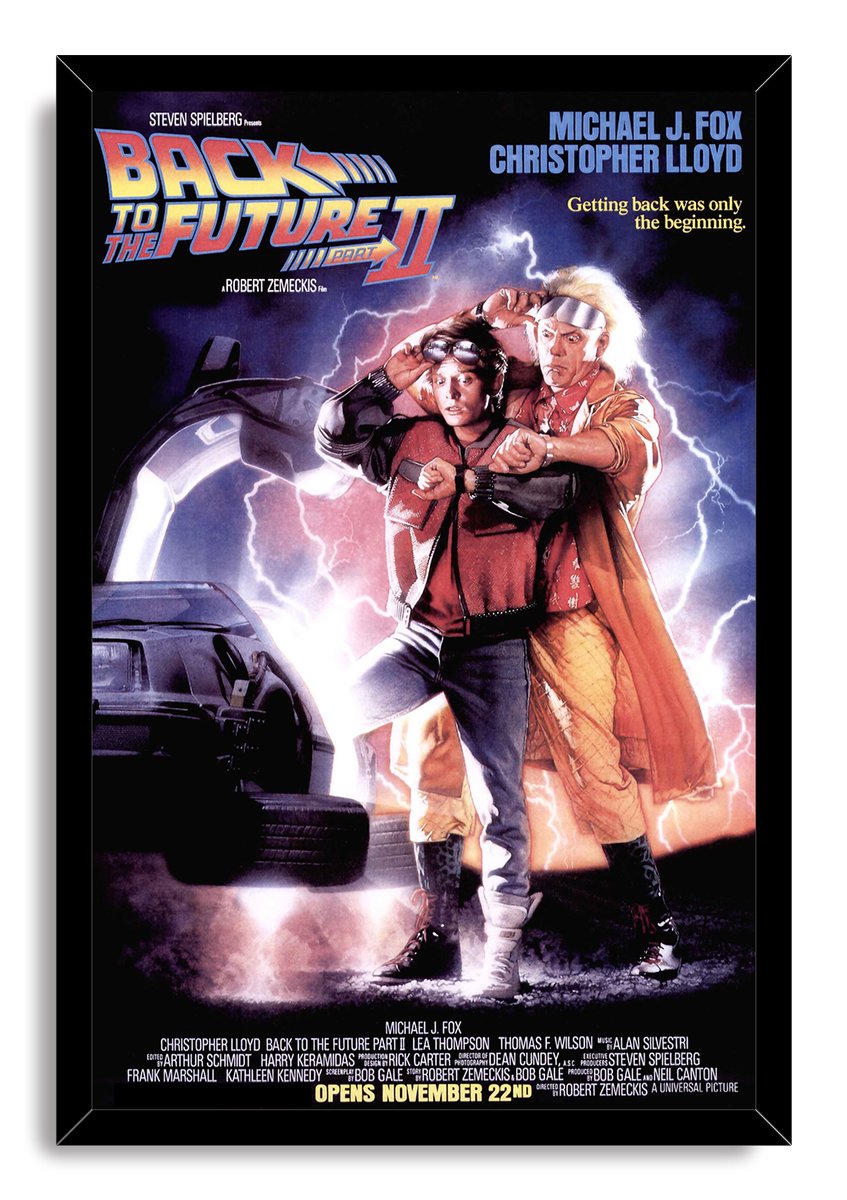 Back to the Future Part II framed wall art print with Marty and Doc beside the DeLorean against a glowing lightning storm.