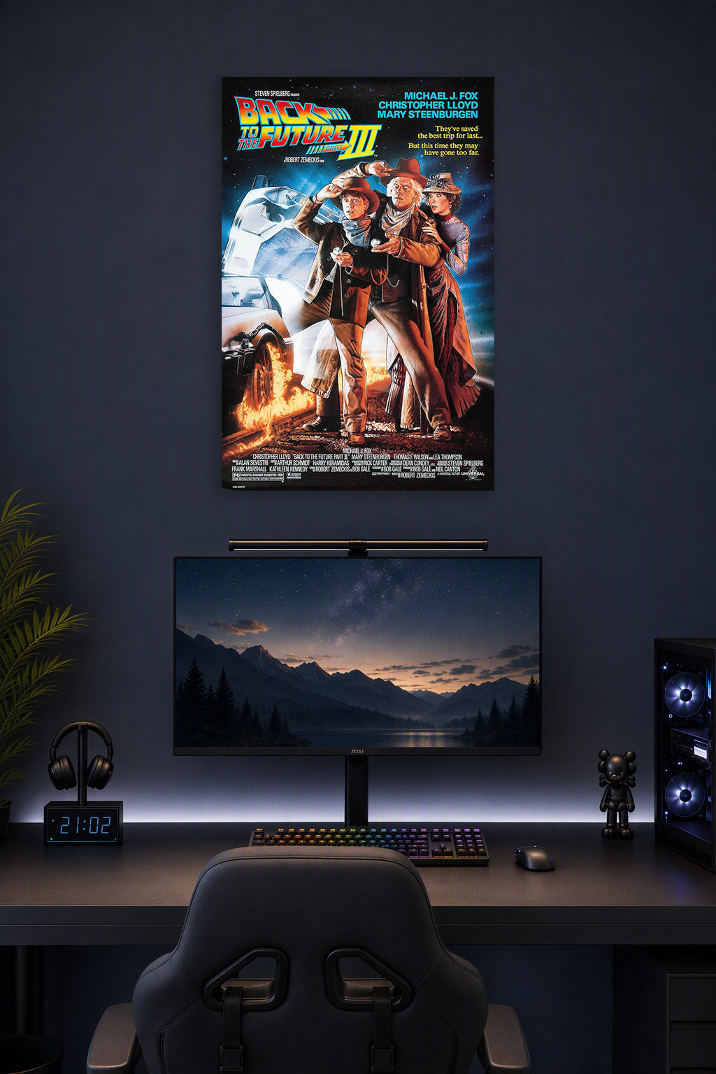 Back to the Future Part III Movie Poster in a gaming desk setup above a monitor.