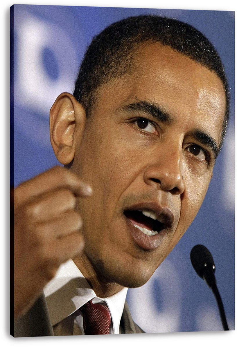 Barack Obama canvas wall art print features a close-up speech pose, raised fist, red tie, microphone, and blue backdrop.