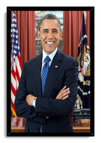 Barack Obama framed wall art print features his smiling arms-crossed portrait in a black frame, with flags behind him.