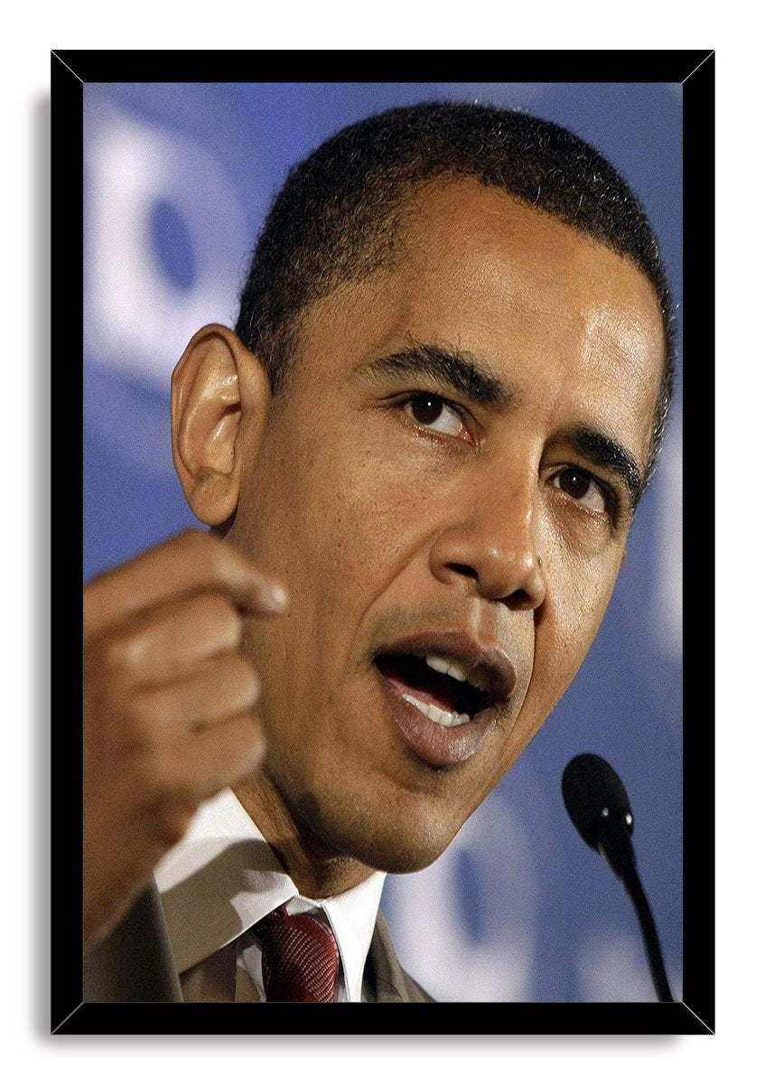 Barack Obama framed wall art print portrays him mid-speech with a raised fist and microphone in a black frame.