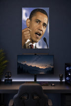 Barack Obama in a gaming desk setup above a monitor.