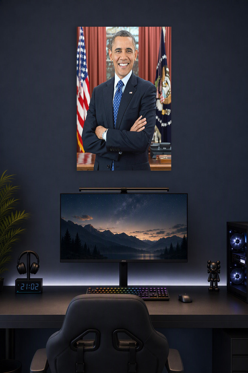 Barack Obama in a gaming desk setup above a monitor.
