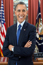 Barack Obama wall art print features a smiling formal portrait in a navy suit before American and presidential flags.