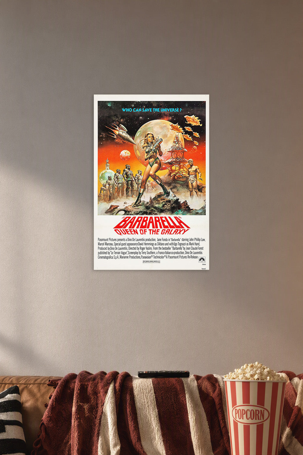 Barbarella Queen of the Galaxy Movie Poster in a cozy movie room above a brown sofa with popcorn.