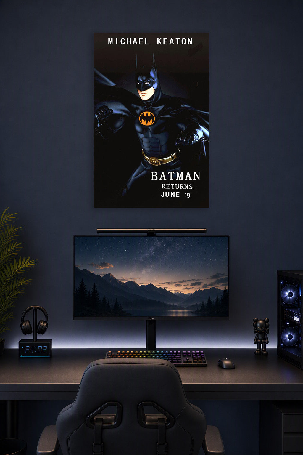 Batman Michael Keaton in a gaming desk setup above a monitor.