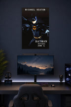 Batman Michael Keaton in a gaming desk setup above a monitor.