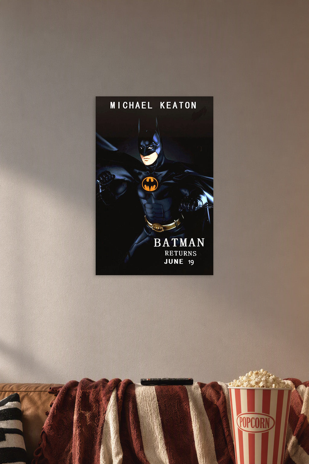 Batman Michael Keaton in a cozy movie room above a brown sofa with popcorn.