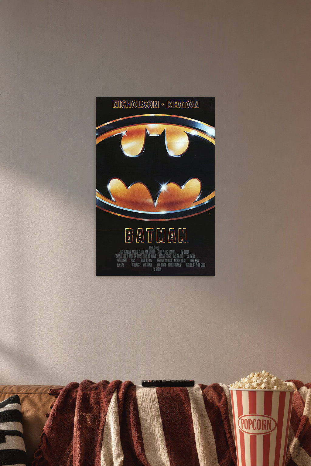 Batman Movie in a cozy movie room above a brown sofa with popcorn.