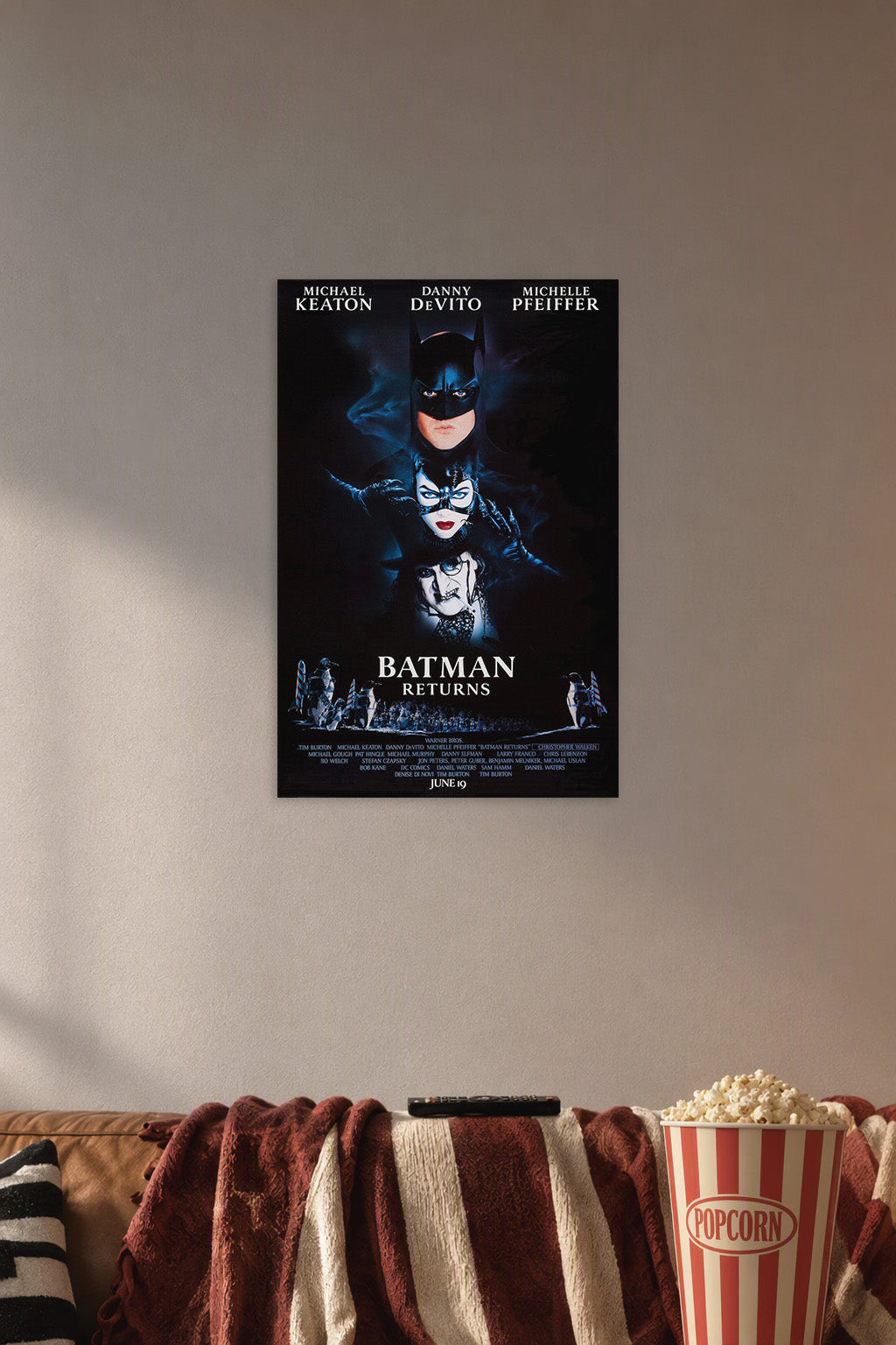 Batman Returns Movie Poster in a cozy movie room above a brown sofa with popcorn.