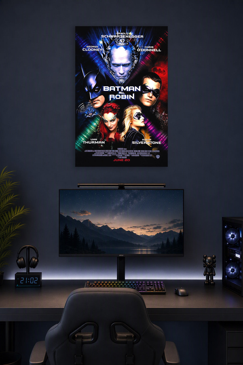 Batman & Robin Movie Poster in a gaming desk setup above a monitor.