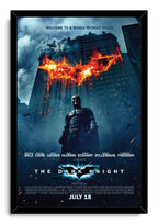 Batman The Dark Knight framed wall art print with Batman, stormy blue skyscrapers, and a glowing orange bat symbol.