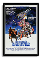 Battlestar Galactica framed wall art print displays silver robots under a spacecraft, armed heroes, and blue science-fiction title lettering.