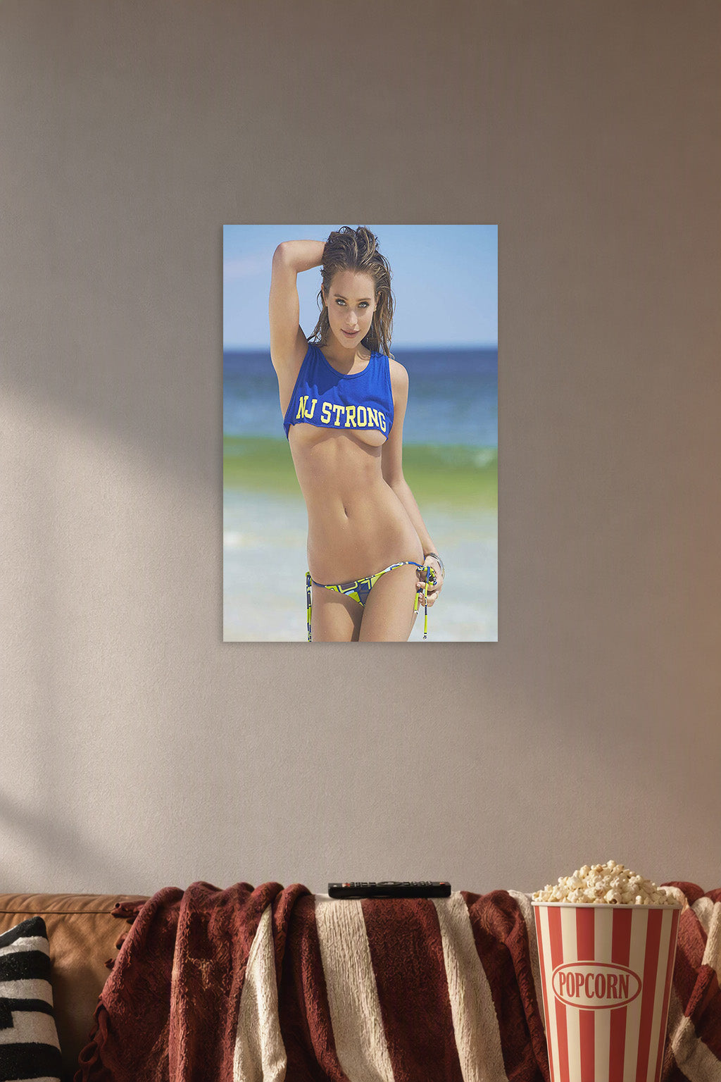 Beautiful Woman on Beach in a cozy movie room above a brown sofa with popcorn.