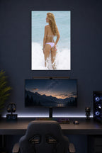 Bella Thorne in a gaming desk setup above a monitor.