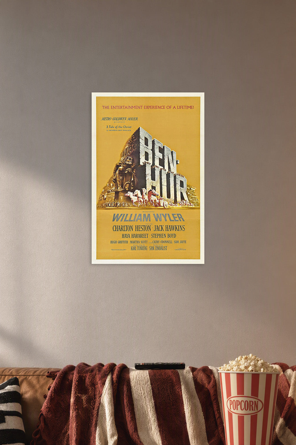Ben-Hur Movie Poster in a cozy movie room above a brown sofa with popcorn.