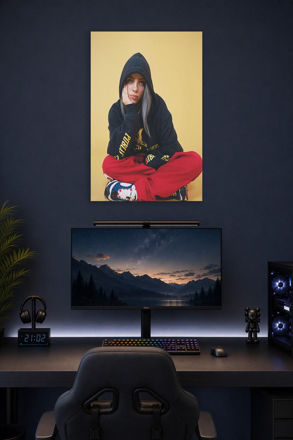 Billie Eilish in a gaming desk setup above a monitor.