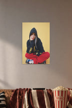 Billie Eilish in a cozy movie room above a brown sofa with popcorn.