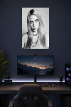 Billie Eilish in a gaming desk setup above a monitor.