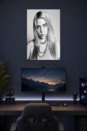Billie Eilish in a gaming desk setup above a monitor.
