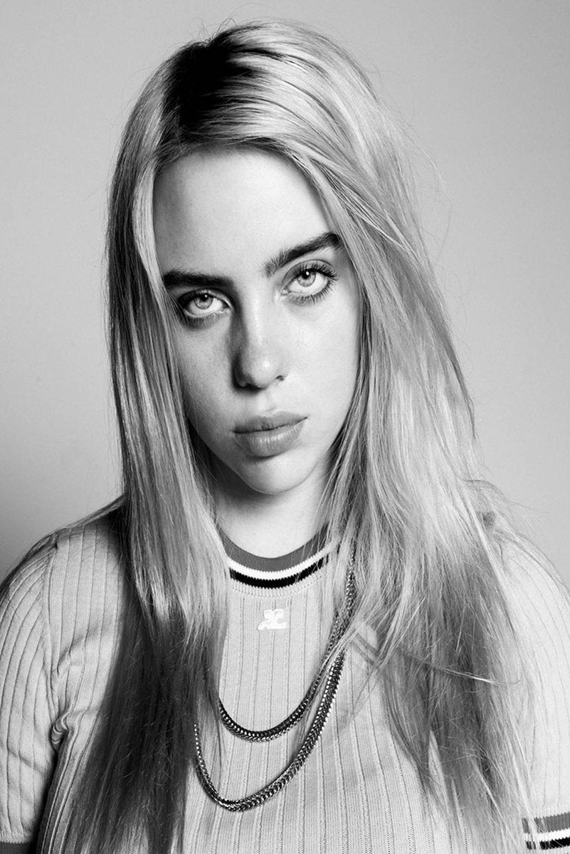 Billie Eilish wall art print features a black-and-white close-up portrait with long hair, layered chains, and a striped ribbed top.
