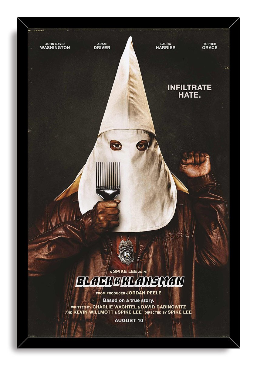 BlacKkKlansman framed wall art print with a hooded figure in a leather jacket holding an afro pick against black.