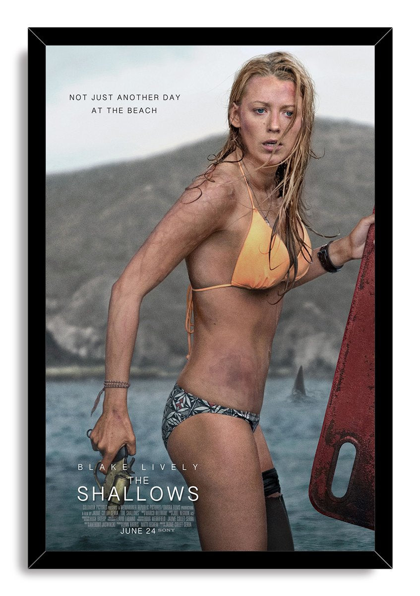 The Shallows framed wall art print features Blake Lively in swimwear holding a red surfboard against a gray coastal sea.