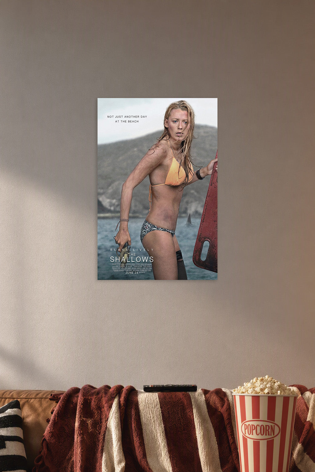 Blake Lively The Shallows Movie Poster in a cozy movie room above a brown sofa with popcorn.