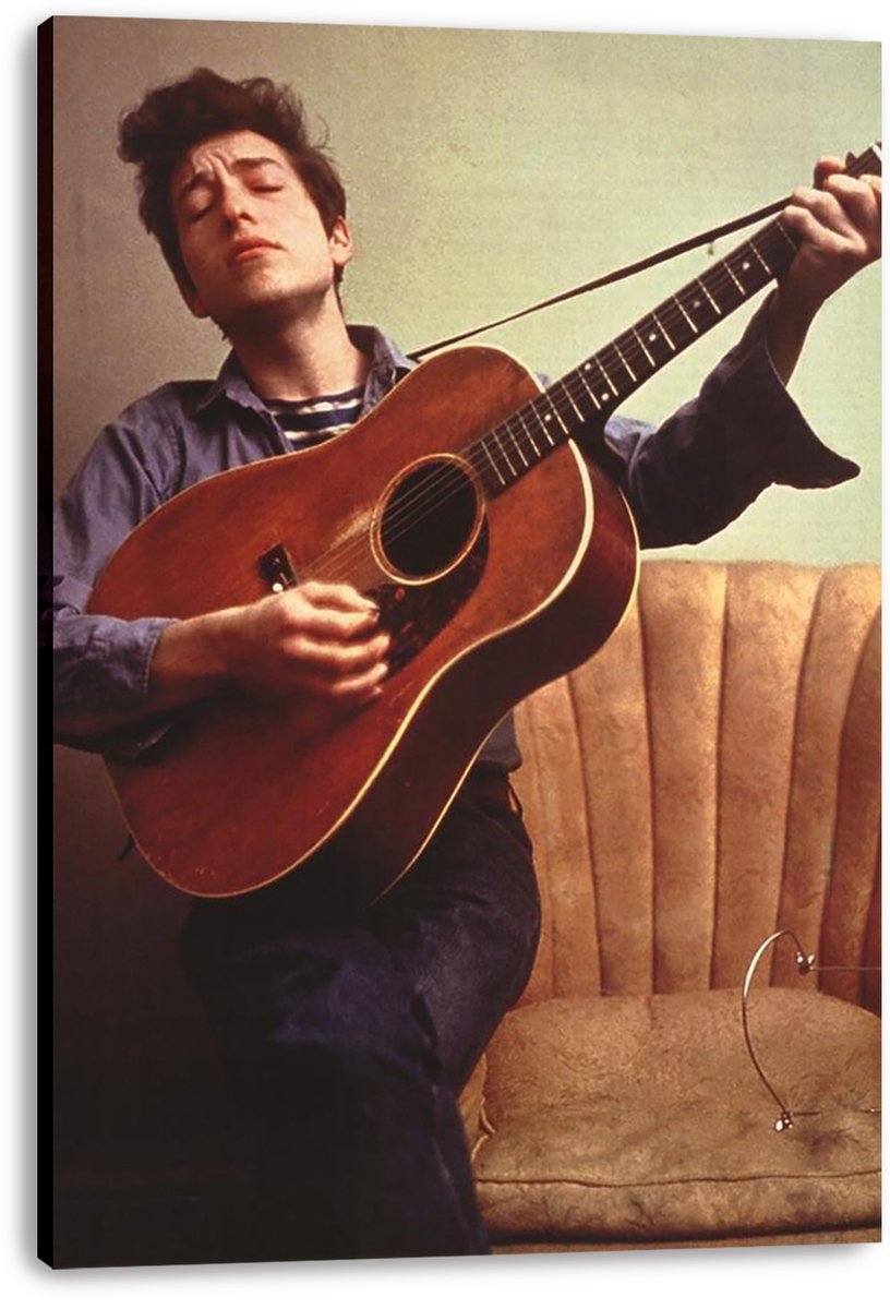 Bob Dylan canvas wall art print depicts the musician playing a brown acoustic guitar with eyes closed beside a tan chair.