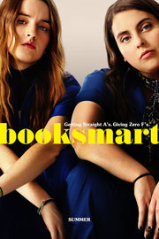 Booksmart poster featuring two young women in blue outfits seated close together, with bold yellow title text.