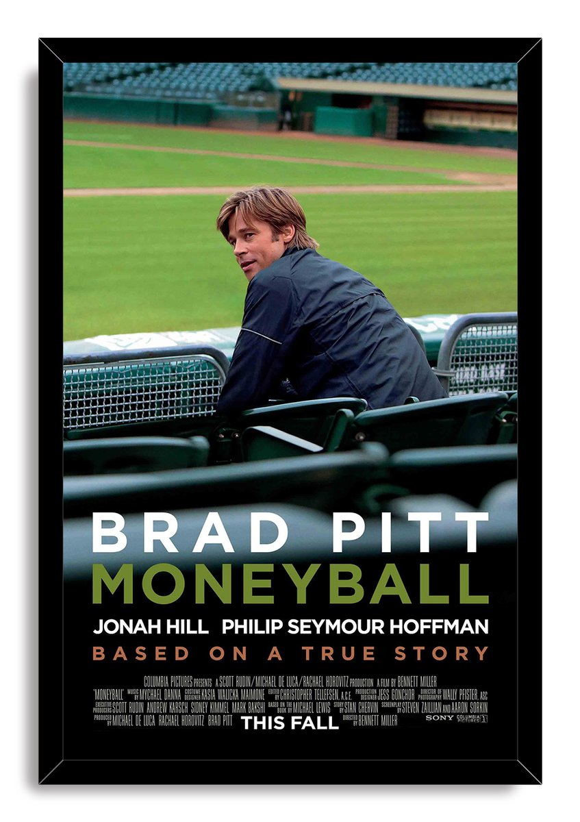 Moneyball framed wall art print with Brad Pitt at a baseball stadium, green field backdrop, black frame, and movie credits.