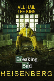 Breaking Bad Heisenberg poster features Walter White in a yellow hazmat suit amid cash and blue barrels in a shadowy warehouse.