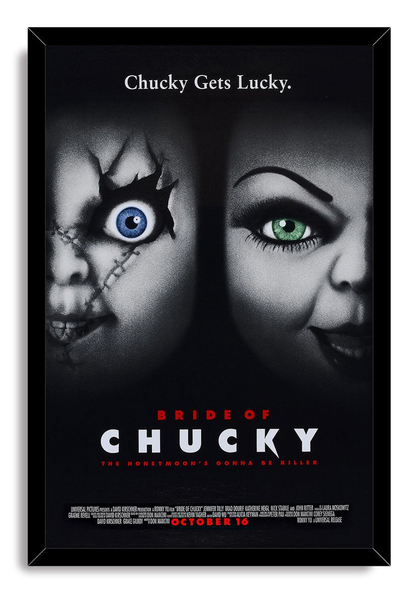 Bride of Chucky framed wall art print presents Chucky and Tiffany's shadowed faces, contrasting blue and green eyes, and red and white film typography.
