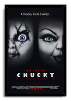 Bride of Chucky framed wall art print presents Chucky and Tiffany's shadowed faces, contrasting blue and green eyes, and red and white film typography.