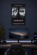 Bride of Chucky in a gaming desk setup above a monitor.