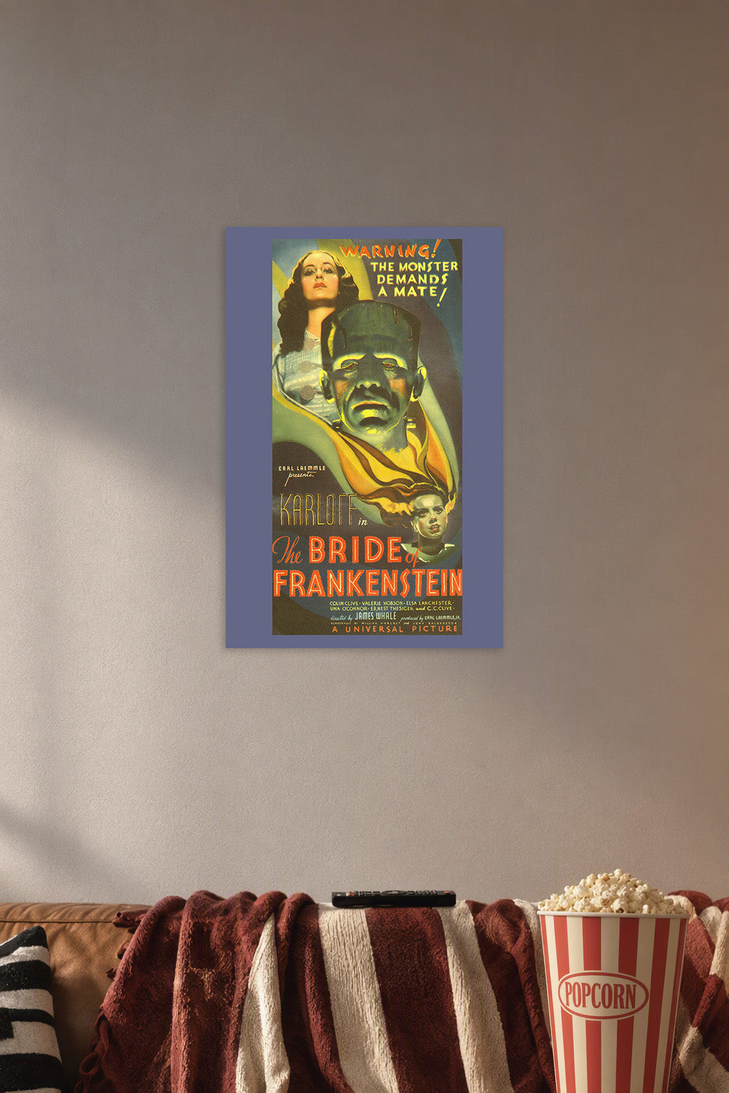 Bride of Frankenstein Movie Poster in a cozy movie room above a brown sofa with popcorn.